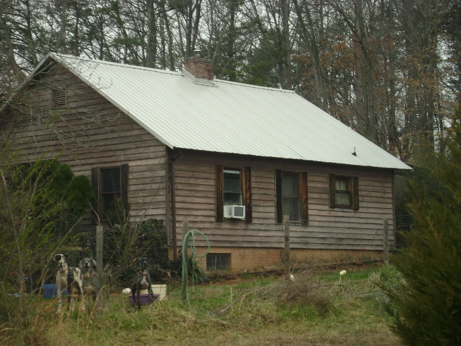 White metal roof on an old wood sided farmhouse, from a Metal Roof Installation job in Eastview